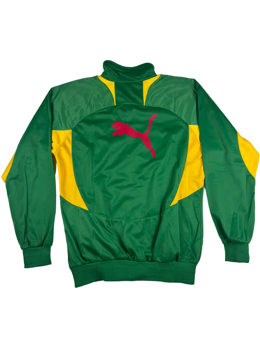 Green and yellow tracksuit with a pink logo on a light gray background